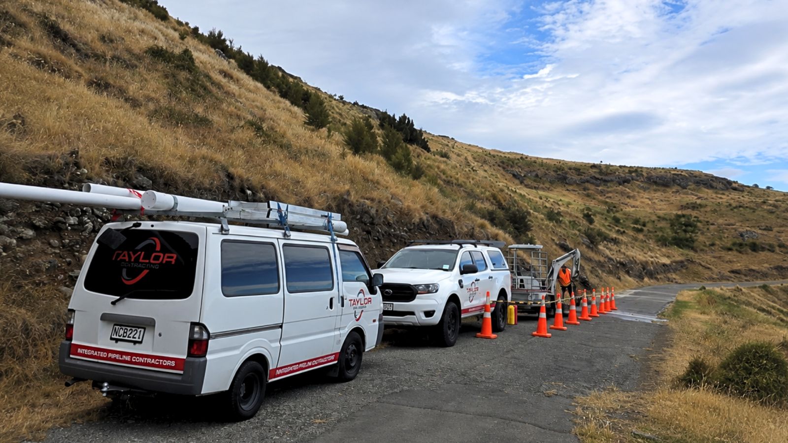 Taylor Plumbing van, ute and mini excavator on a Palmerston North job site